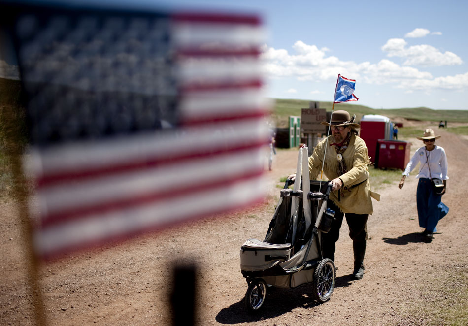 A man wheels his gun cart to a firing stall during Hell on Wheels on Friday, July 1, 2011, at the Cheyenne Regulators Range west of Cheyenne.