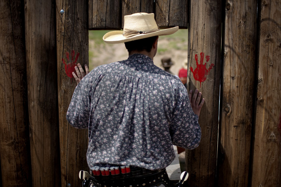 A man watches a participant take part in Hell on Wheels on Friday, July 1, 2011, at the Cheyenne Regulators Range west of Cheyenne.