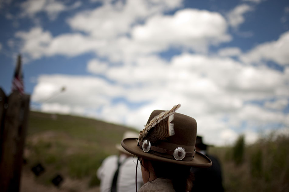 A woman watches a round of shooting during Hell on Wheels on Friday, July 1, 2011, at the Cheyenne Regulators Range west of Cheyenne.