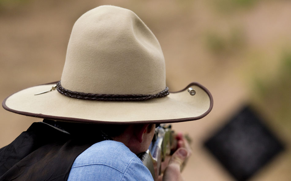A rifle shell casing ejects over the shooter's cowboy hat during Hell on Wheels on Friday, July 1, 2011, at the Cheyenne Regulators Range west of Cheyenne.