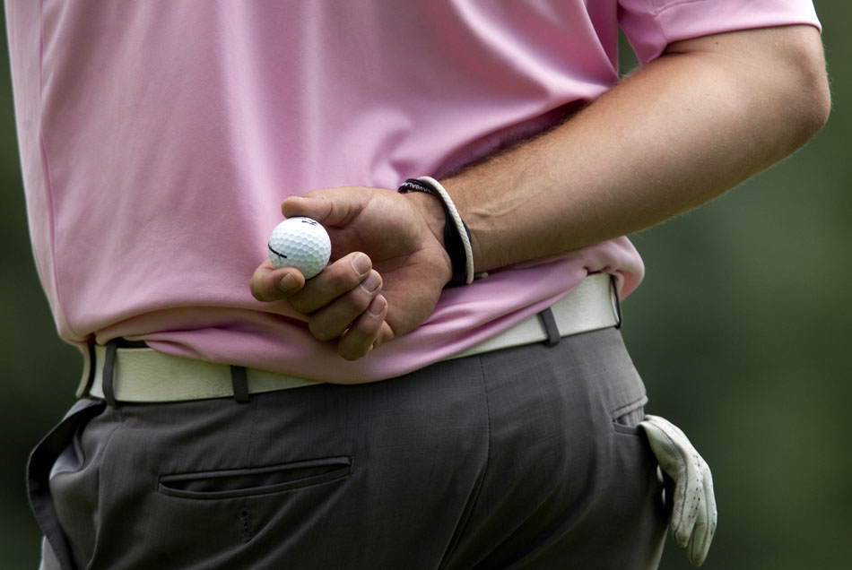 Patrick Manning holds his ball behind his back as he waits for other golfers in his group to hole out on No. 7, a 202-yard par 3, during the second round of the 55th Tyrrell-Doyle Wyoming Open on Saturday, July 9, 2011, at the Airport Golf Course in Cheyenne, Wyo.