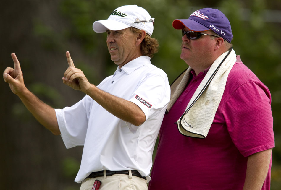 Chris Johnson lines up a putt with his caddie, Tal Neemann, on No. 9, a 156-yard par 3, during the second round of the 55th Tyrrell-Doyle Wyoming Open on Saturday, July 9, 2011, at the Airport Golf Course in Cheyenne, Wyo. Johnson faced a long up-hill putt for birdie that he left several feet short. He was able to tap in for par.