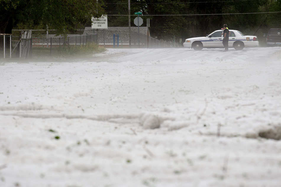 Fog rises off of a river of hail as police block Bradley Avenue at the intersection of 22nd Street on Tuesday, July 12, 2011, in Cheyenne.