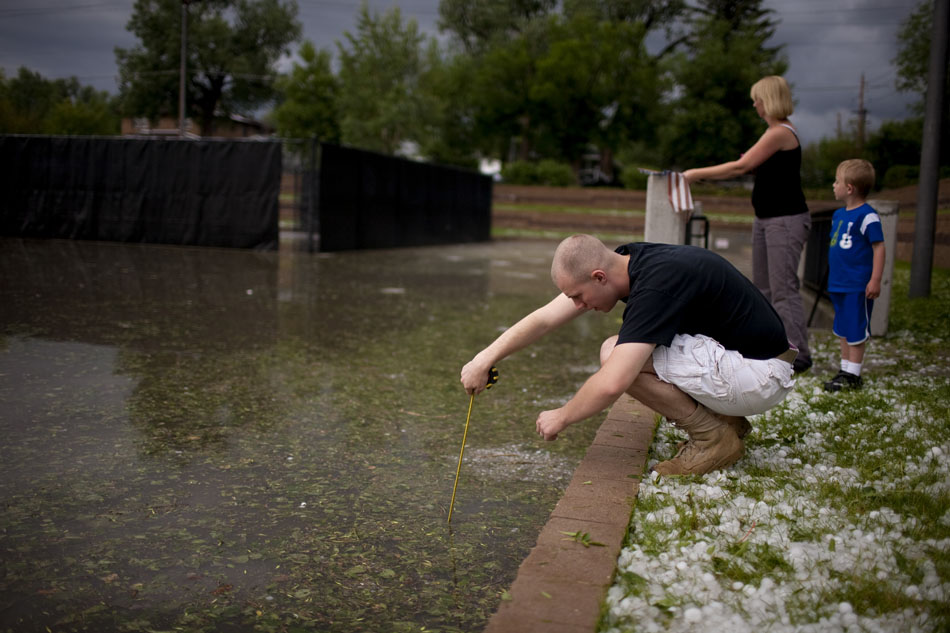 Benjamin Sweeney uses a tape measure to get the depth of the water in Pando Park on Tuesday, July 12, 2011, in Cheyenne. His tape measure hit the bottom at 41 inches.