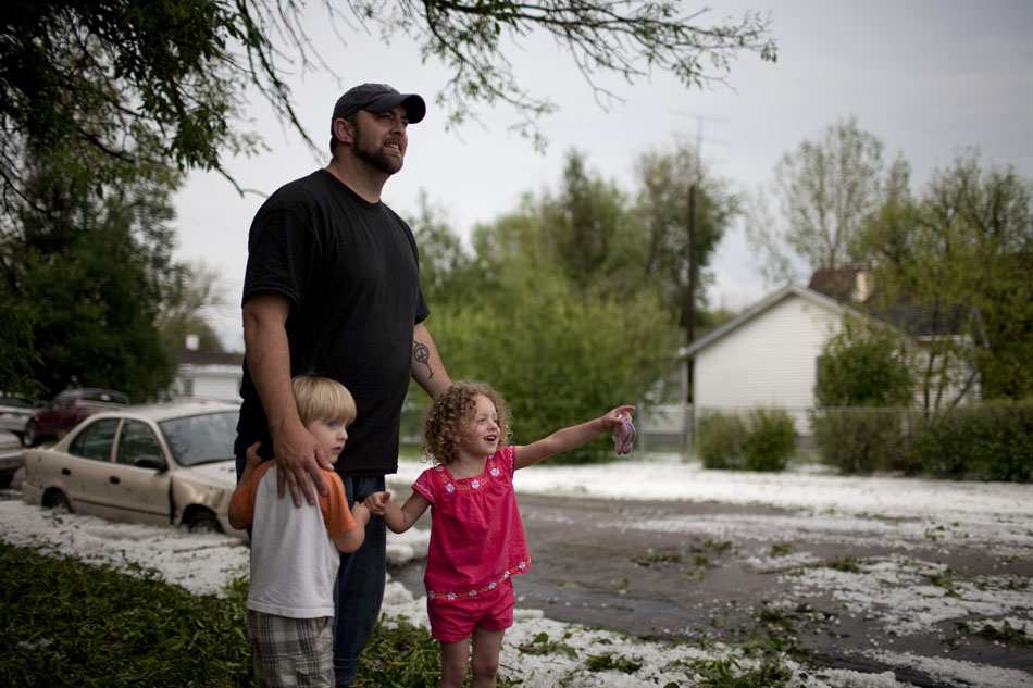 Brianna Portes, 3, points at a front loader as it unclogs the intersection of Bradley Avenue and 23rd Street as she stands with her babysitter, Brad Eddy, and his son, Otto Eddy, 3, on Tuesday, July 12, 2011, in Cheyenne.