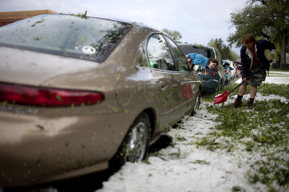 Residents use a shovel to dig a vehicle out of a mound of hail on Tuesday, July 12, 2011, along 23rd Street near the intersection with Bradley Avenue in Cheyenne.