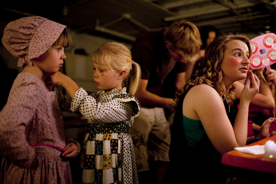 Rose Threewitt, center, 7, helps her sister, Maggie Threewitt, 7, get her costume on as Mandy Hill, who plays the part of the heroine Lacie Camisole, puts on her makeup before the opening night of the 55th Old Fashioned Melodrama on Thursday, July 14, 2011, at the Atlas Theatre in Cheyenne. The melodrama continues through Aug. 7.