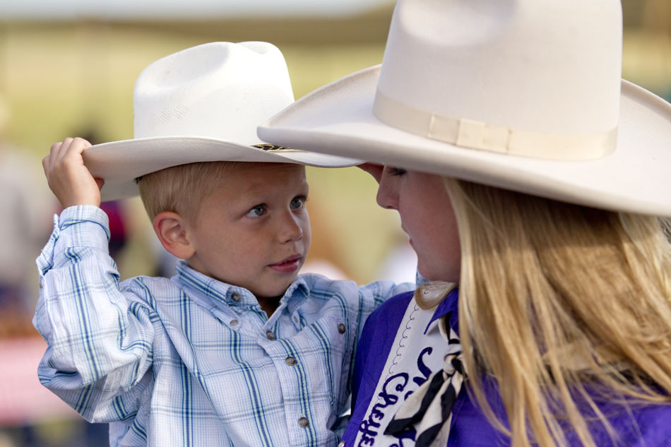 Dane Burnside, 5, adjusts his cowboy hat as he talks to Cheyenne Frontier Days Miss Frontier Amy Berry during the chuckwagon breakfast before the CFD cattle drive on Sunday, July 17, 2011, at a pasture north of Cheyenne.