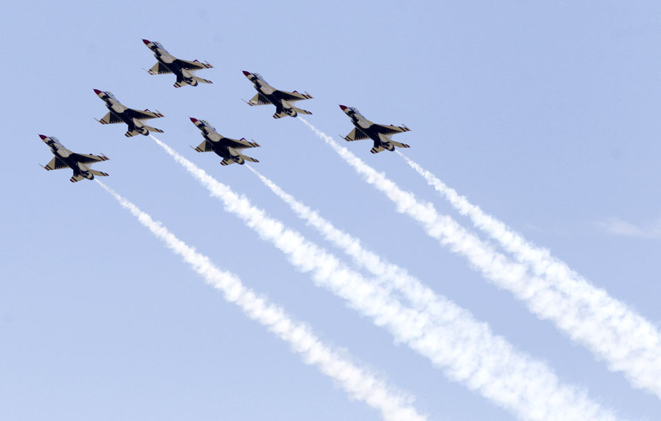 Members of the U.S. Air Force Thunderbirds soar over the Cheyenne skys above Laramie County Community College during a performance on Wednesday, July 27, 2011, on the city's southeast side. A crowd of about 14,000 spectators came out to watch "America's Ambassadors in Blue" perform backdropped against blue skies.