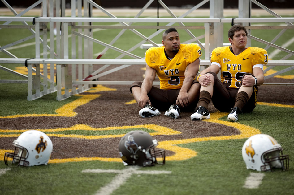Wyoming running back Kody Sutton, left, and Trey Fox wait in front of bleachers as they are lined up for the team's photo during the University of Wyoming's media day on Saturday, Aug. 6, 2011, at Memorial Stadium in Laramie.
