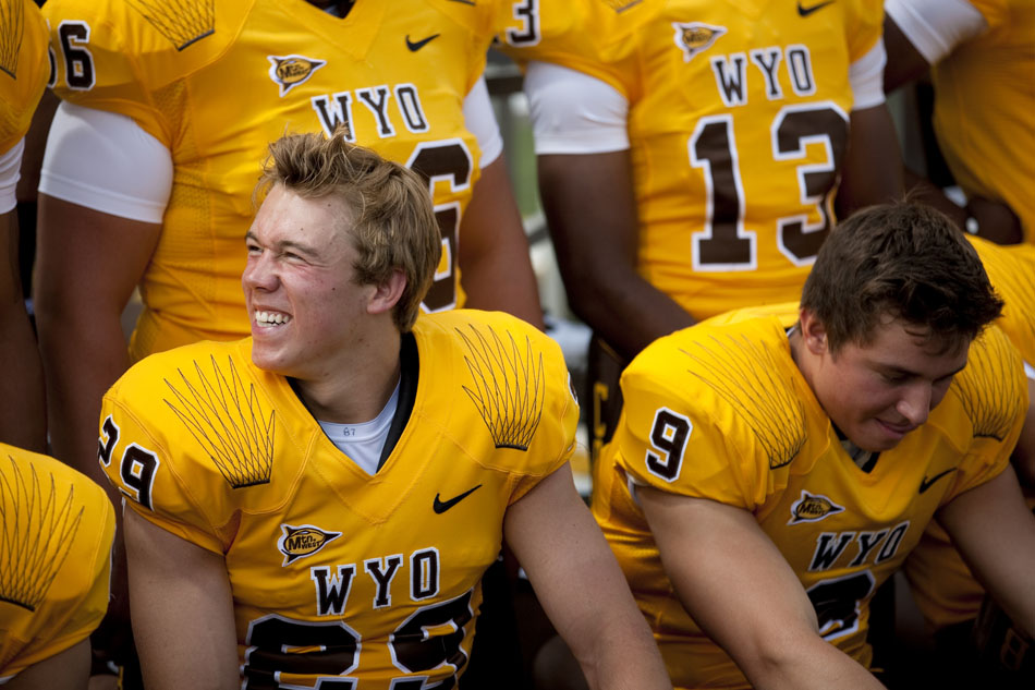 Wyoming strong safety Luke Ruff shares a laugh with teammates as they wait for the team's photo to be taken during the University of Wyoming's media day on Saturday, Aug. 6, 2011, at Memorial Stadium in Laramie.