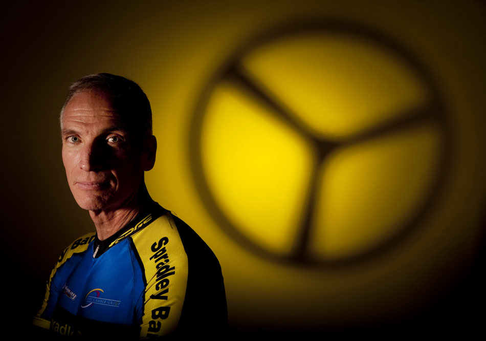 John Cox, the WYDOT director, poses for a portrait on Tuesday, Aug. 9, 2011, with the front wheel of his time trial bicycle shadowed in the background. Cox is competing in the cycling time trial and road race in this year's senior olympics. (James Brosher/Wyoming Tribune Eagle)