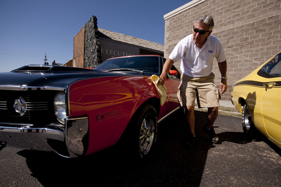 Terry Hoyt wipes down the side of his 1970 AMX, a two-seater muscle car built by the American Motors Corporation between 1968 and 1970, during the Cowboy Classic MOPAR Show on Saturday, Aug. 20, 2011, in Cheyenne. Hoyt ordered the car in November 1969 and picked it up on Feb. 25, 1970. It is one of only 122 cars AMC built in 1970 with an orange and flat black paint scheme. Hoyt said that he dated his wife, Susan, in the car after he bought it.