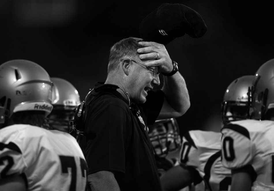 The Cheyenne South defensive coordinator wipes his face as he talks to his players during a Class 4A football game between Cheyenne South and Natrona County on Friday, Aug. 26, 2011, at Natrona County High School in Casper, Wyo.