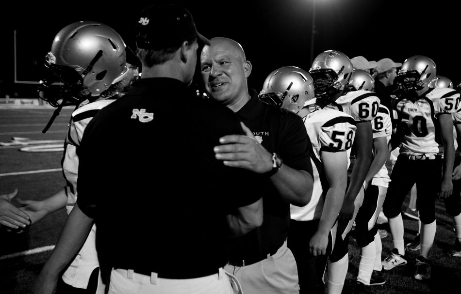 Cheyenne South coach Tracy Pugh talks with a Natrona County coach after a 62-0 loss on Friday, Aug. 26, 2011, at Natrona County High School in Casper, Wyo.