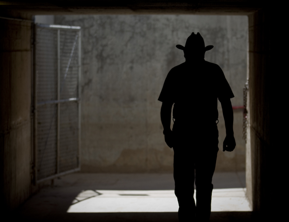 A spectator walks through a tunnel that connects the Frontier Park infield to the parking lot during Cheyenne Frontier Days steer roping on Friday, July 22, 2011, at Frontier Park.