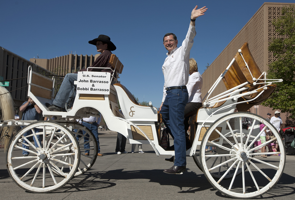 U.S. Sen. John Barrasso, R-Wyo., waves as he rides in a carriage during the Cheyenne Frontier Days parade on Saturday, July 23, 2011, in downtown Cheyenne.