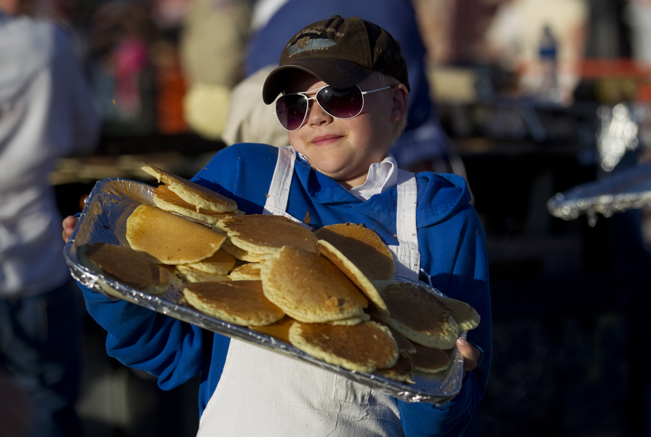 Jay Matheson, 13, leans his tray back to catch a wayward pancake during the Cheyenne Frontier Days Pancake Breakfast on Monday, July 25, 2011, at the Depot Plaza.