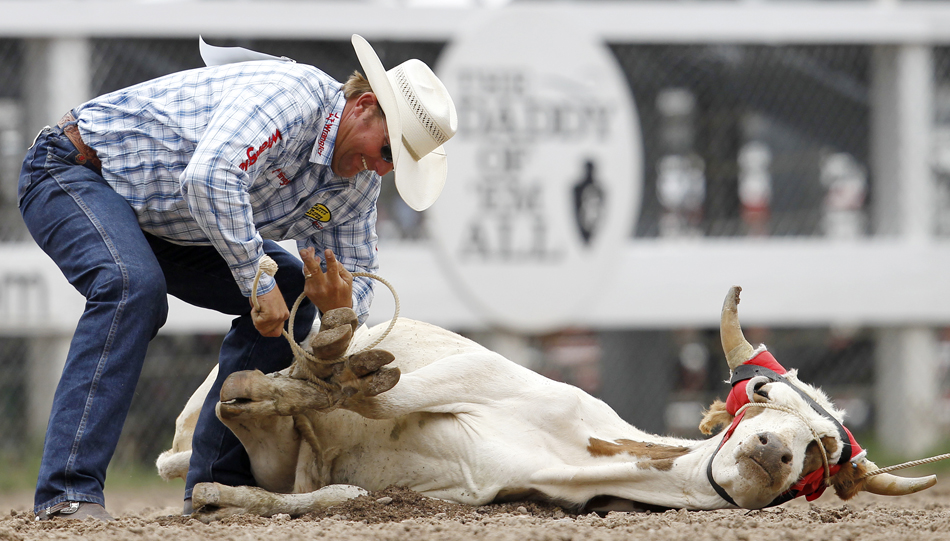 Chance Kelton from Mayer, Ariz. ropes a steer during the Cheyenne Frontier Days rodeo on Tuesday, July 26, 2011, at Frontier Park. Kelton logged a time of 15.7 seconds.