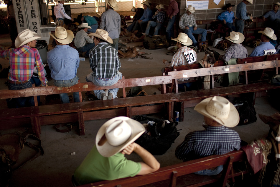 Participants wait for their turns to ride behind the chutes during the Cheyenne Frontier Days rodeo on Friday, July 29, 2011, at Frontier Park.