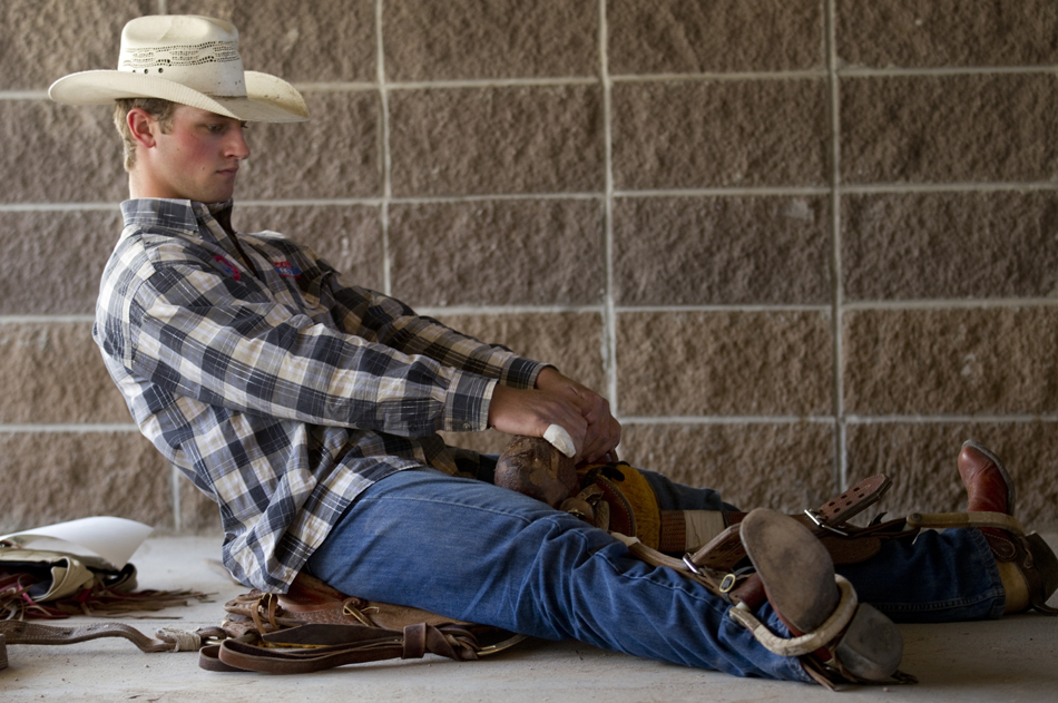 Riley Knoll from Mandan, N.D. practices a riding technique in his saddle in a ready area behind the main chutes before the Cheyenne Frontier Days rodeo on Friday, July 29, 2011, at Frontier Park.