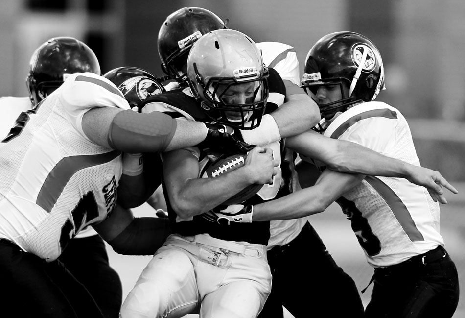 Cheyenne Central defenders swarm Cheyenne South's Cody Dunn as he carries the ball during a Class 4A football game on Friday, Sept. 2, 2011, at Cheyenne South High School. Central won 63-0.