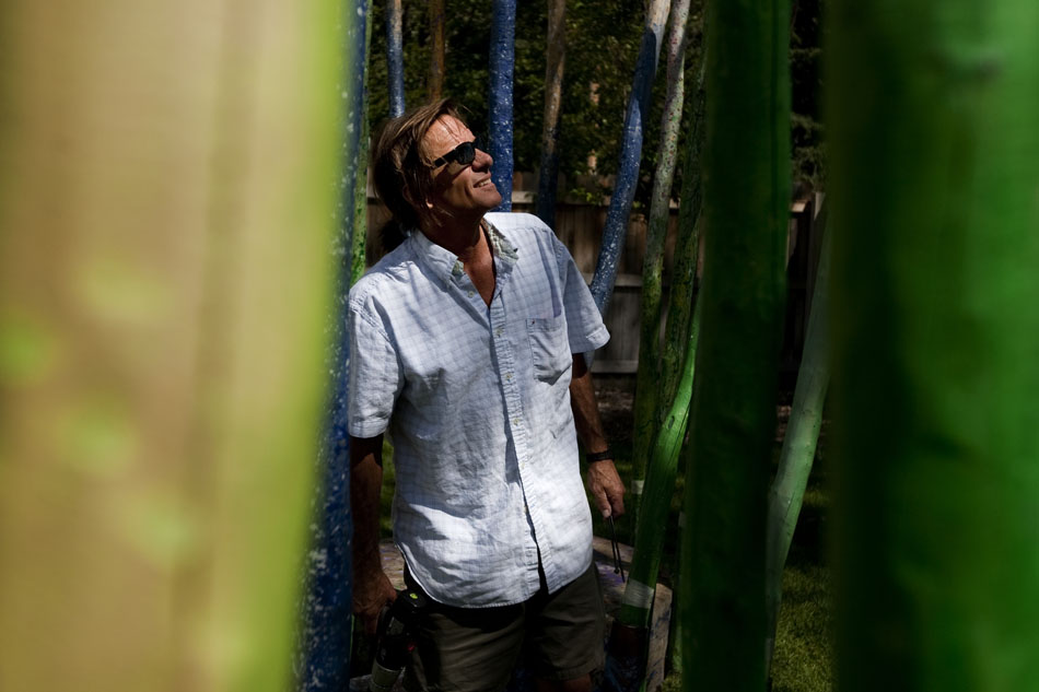 Sculptor Tim Upham from Fort Collins, Colo. surveys his sculpture, "Water to the Garden," on Friday, Sept. 2, 2011, at the Paul Smith Children's Village at the Botanic Gardens. The sculpture, comprised of 75 lodgepole pine trees, will be on display through Halloween.