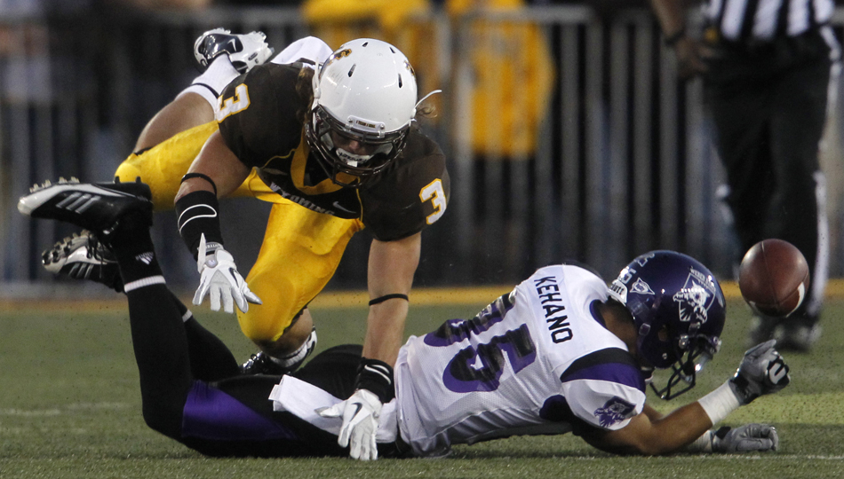 A pass intended for Weber State wide receiver Shaydon Kehano falls incomplete as he's covered by Wyoming safety Luke Anderson during a NCAA college football game on Saturday, Sept. 3, 2011, at War Memorial Stadium in Laramie, Wyo.