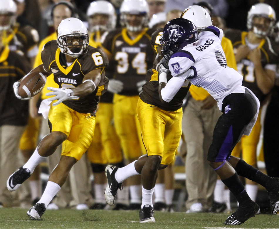 Wyoming wide receiver Robert Herron makes a cut after a catch during a NCAA college football game on Saturday, Sept. 3, 2011, at War Memorial Stadium in Laramie, Wyo.