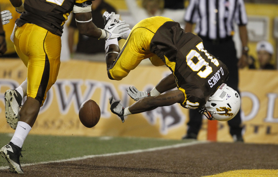 Wyoming cornerback DeAndre Jones (16) does a backflip as he tries to down the football at the one-yard line on a punt during a NCAA college football game on Saturday, Sept. 3, 2011, at War Memorial Stadium in Laramie, Wyo.