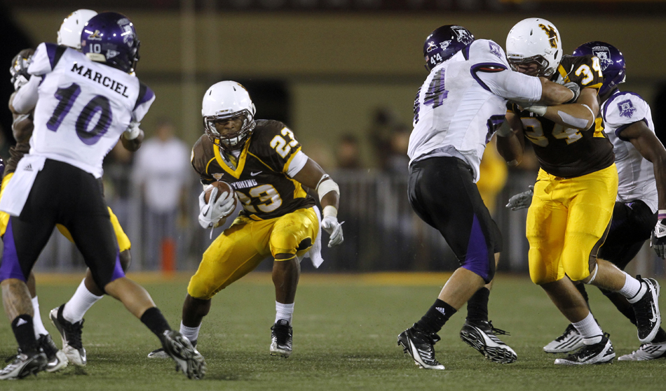 Wyoming running back Ghaali Muhammad finds the hole during a NCAA college football game on Saturday, Sept. 3, 2011, at War Memorial Stadium in Laramie, Wyo.