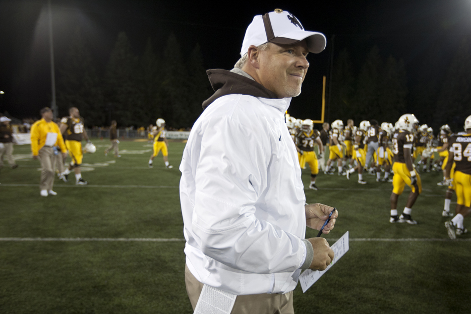 Wyoming head coach Dave Christensen smiles as he walks on the field after a win on Saturday, Sept. 3, 2011, at War Memorial Stadium in Laramie, Wyo.