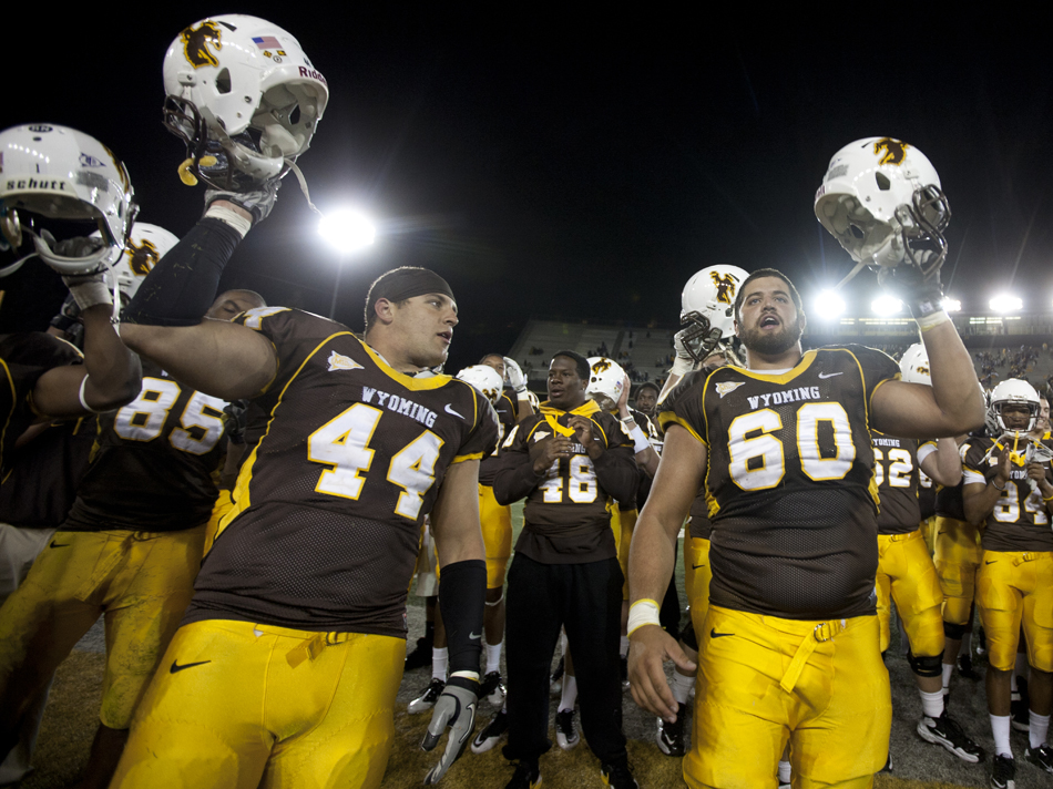 Wyoming players celebrate a 35-32 win over Weber State on Saturday, Sept. 3, 2011, at War Memorial Stadium in Laramie, Wyo.