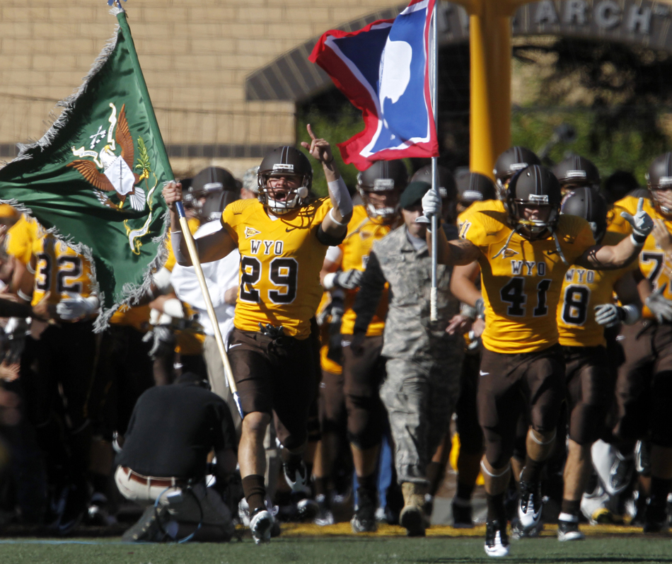 Wyoming safety Luke Ruff (29) and safety Andrew Meredith (41) lead the team onto the field before a NCAA college football game on Saturday, Sept. 10, 2011, at War Memorial Stadium in Laramie, Wyo.