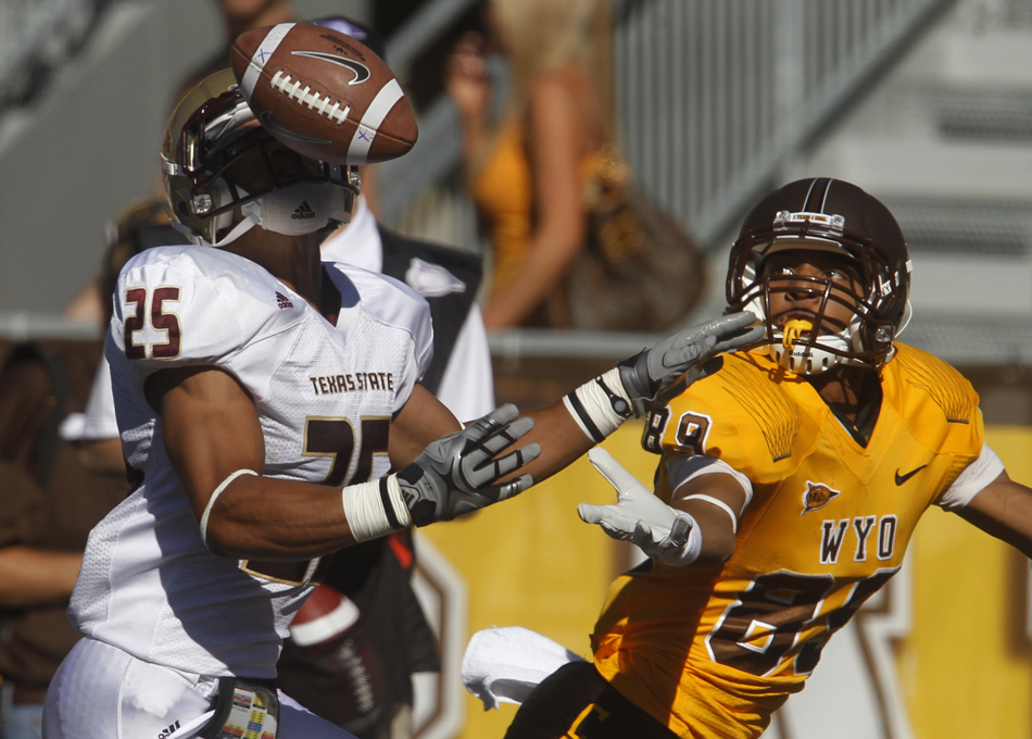 The ball bounces off the facemask of Texas State cornerback Lee Asemota (25) as Wyoming wide receiver Josh Doctson looks to make a catch in the endzone during a NCAA college football game on Saturday, Sept. 10, 2011, at War Memorial Stadium in Laramie, Wyo.