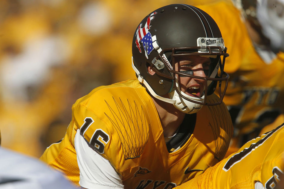 Wyoming quarterback Brett Smith snaps the ball from under center during a NCAA college football game on Saturday, Sept. 10, 2011, at War Memorial Stadium in Laramie, Wyo.