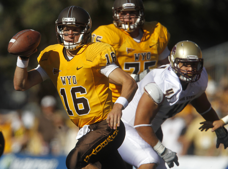 Wyoming quarterback Brett Smith scrambles out of the pocket during a NCAA college football game on Saturday, Sept. 10, 2011, at War Memorial Stadium in Laramie, Wyo.