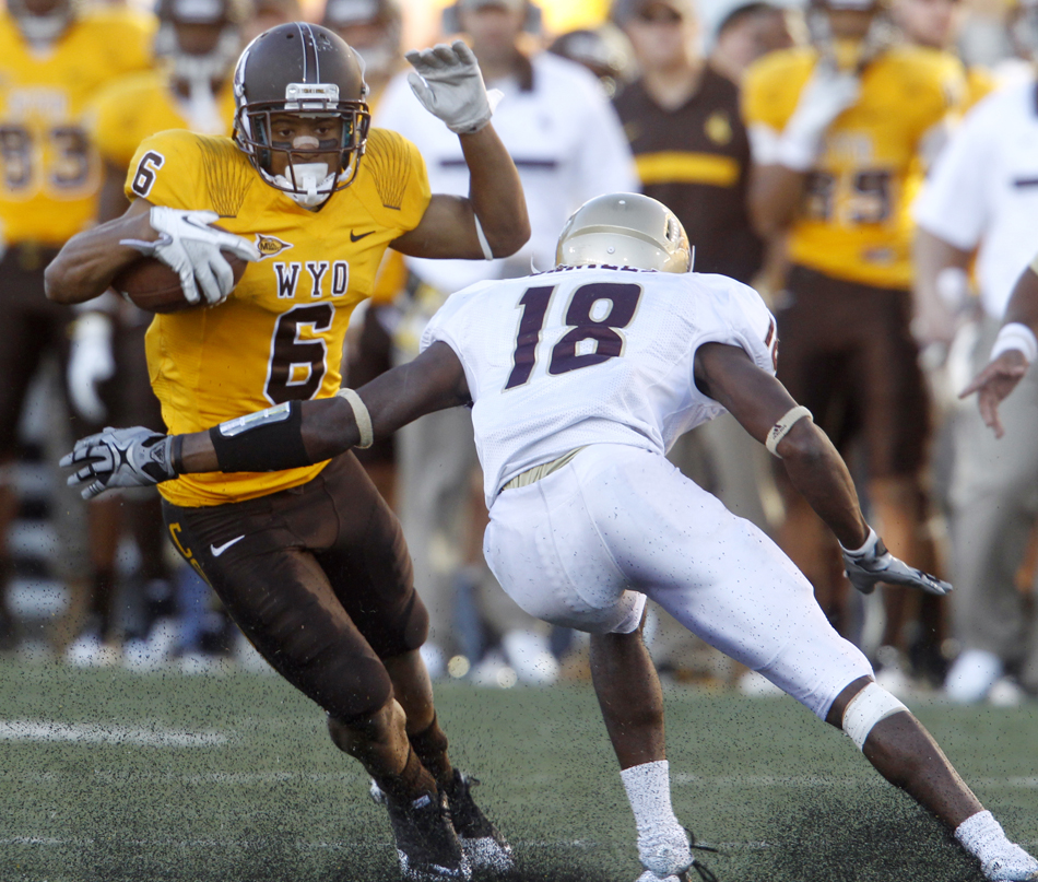 Wyoming wide receiver Robert Herron jukes Texas State defensive back Xavier Daniels after a reception during a NCAA college football game on Saturday, Sept. 10, 2011, at War Memorial Stadium in Laramie, Wyo.