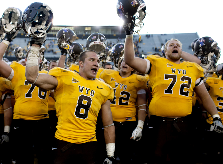 Wyoming linebacker Brian Hendricks (8) and offensive tackle Clayton Kirven (72) celebrate a 45-10 win against Texas State in a NCAA college football game on Saturday, Sept. 10, 2011, at War Memorial Stadium in Laramie, Wyo.