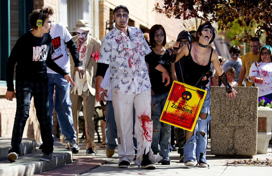 Zombies including Gus White, center, lurch their way north on Carey Avenue towards the Wyoming State Capitol during a Zombie Fest walk on Saturday, Oct. 1, 2011, in Cheyenne.
