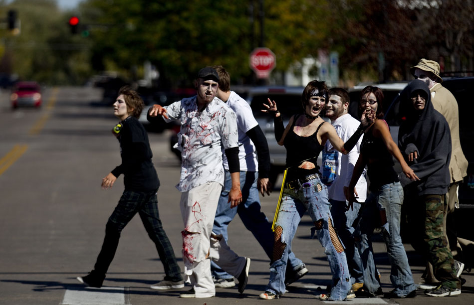 Zombies lurch their way through an intersection on Carey Avenue towards the Wyoming State Capitol during a Zombie Fest walk on Saturday, Oct. 1, 2011, in Cheyenne.