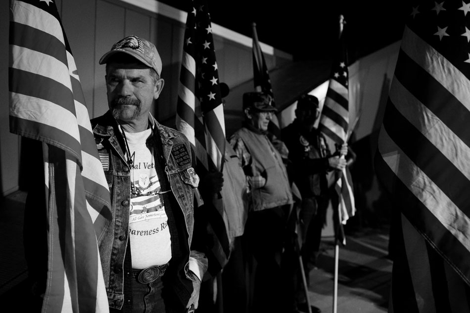 David Skipper, of Cheyenne, holds a flag as he and fellow Patriot Guard Riders wait for the arrival of the Honor Flight on Wednesday, Oct. 12, 2011, on the tarmac at the Cheyenne Regional Airport.