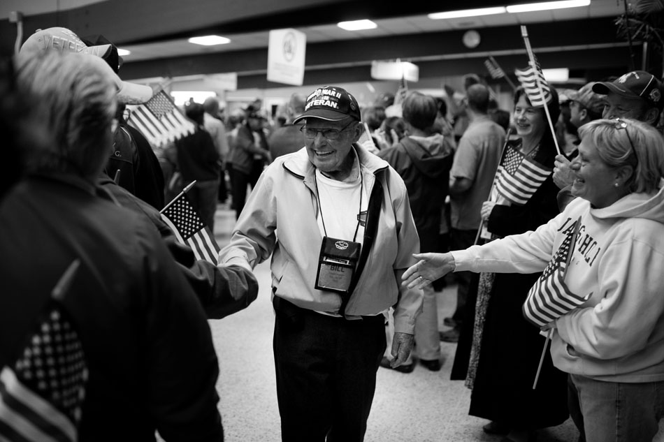 William Vollman, of Douglas, Wyo., shakes hands as he walks through the terminal of the Cheyenne Regional Airport after the Honor Flight's return on Wednesday, Oct. 12, 2011, in Cheyenne. Vollman was one of about 80 veterans to make the trip to the nation's capitol to visit the National World War II Memorial. It was the Honor Flight as the group has exhausted the entire waiting list of Wyoming World War II veterans who wanted to make the journey.