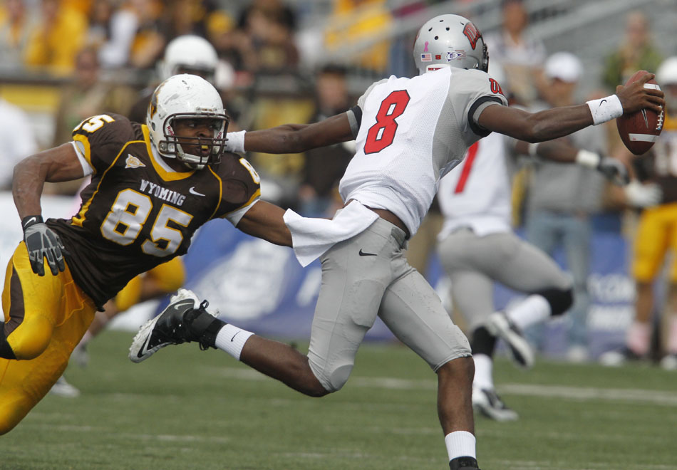 Wyoming defensive end Mark Willis chases down UNLV quarterback Caleb Herring during a NCAA college football game on Saturday, Oct. 15, 2011, in Laramie, Wyo.