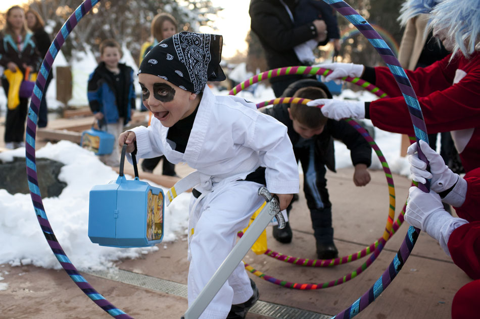 Jarrid Burch, 5, dressed as a ninja, makes his way through hula hoops being held by Thing 1 and Thing 2, characters from "The Cat in the Hat," during the Goblin Walk on Thursday, Oct. 27, 2011, at the Children's Village at the Cheyenne Botanic Gardens.