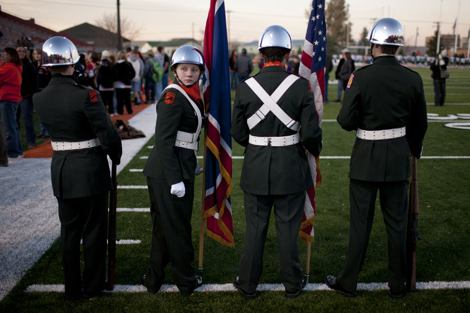 Janessa Scharpe, a member of the Natrona County Army ROTC, looks back as she and fellow color guard members wait to present the colors before a Class 4A football semi-final between Cheyenne East and Natrona County on Friday, Nov. 4, 2011, at Natrona County High School in Casper, Wyo.