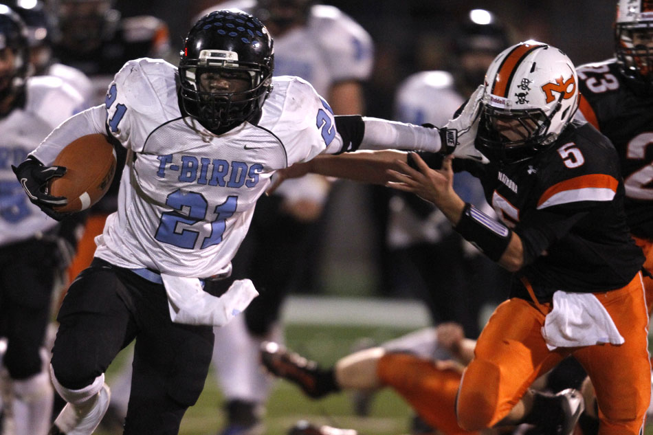 Cheyenne East running back Jeremy Woods stiff arms Natrona County's Cody Vollmar as Woods breaks off a long run during a Class 4A semi-final on Friday, Nov. 4, 2011, at Natrona County High School in Casper, Wyo. East won 24-19 to advance to the state finals.