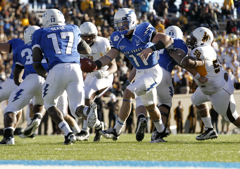 Air Force quarterback Connor Dietz hands off to running back Asher Clark during a NCAA college football game on Saturday, Nov. 12, 2011, at Falcon Stadium in Colorado Springs, Colo.