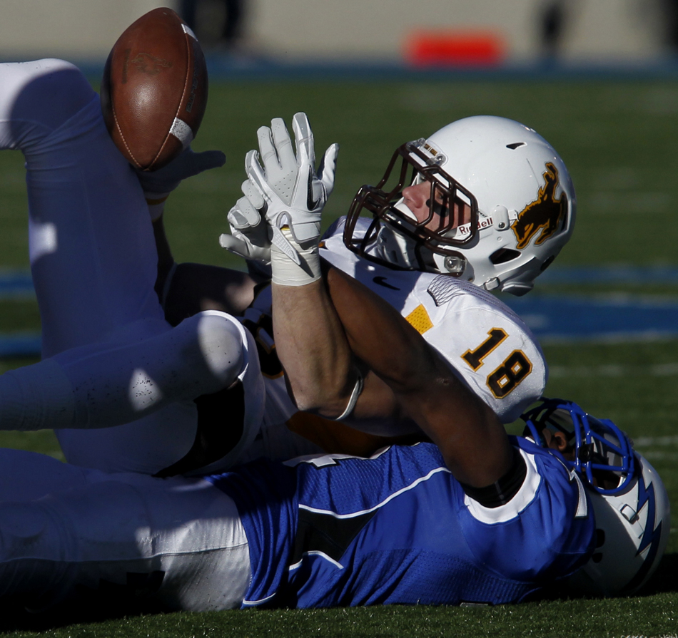 Wyoming running back Brandon Miller (18) drops a would-be reception as he's defended by Air Force defensive back Josh Hall during a NCAA college football game on Saturday, Nov. 12, 2011, at Falcon Stadium in Colorado Springs, Colo.