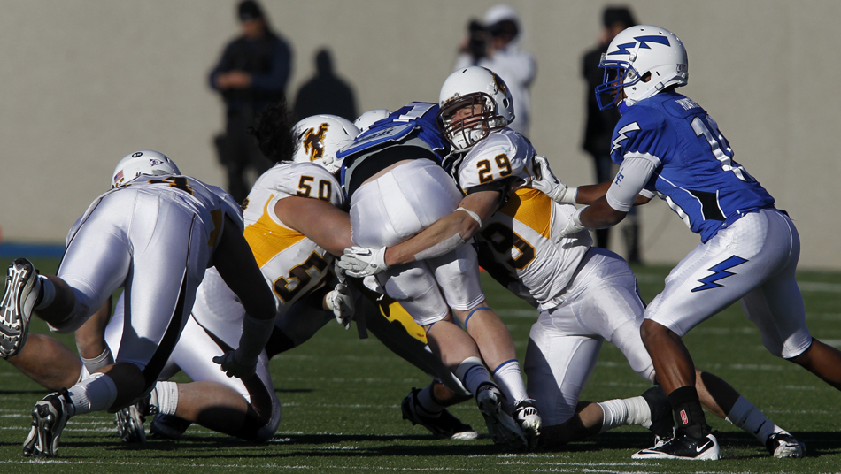 Wyoming safety Luke Ruff (29) and defensive tackle Mike Purcell (50) tackle Air Force quarterback Connor Dietz during a NCAA college football game on Saturday, Nov. 12, 2011, at Falcon Stadium in Colorado Springs, Colo.